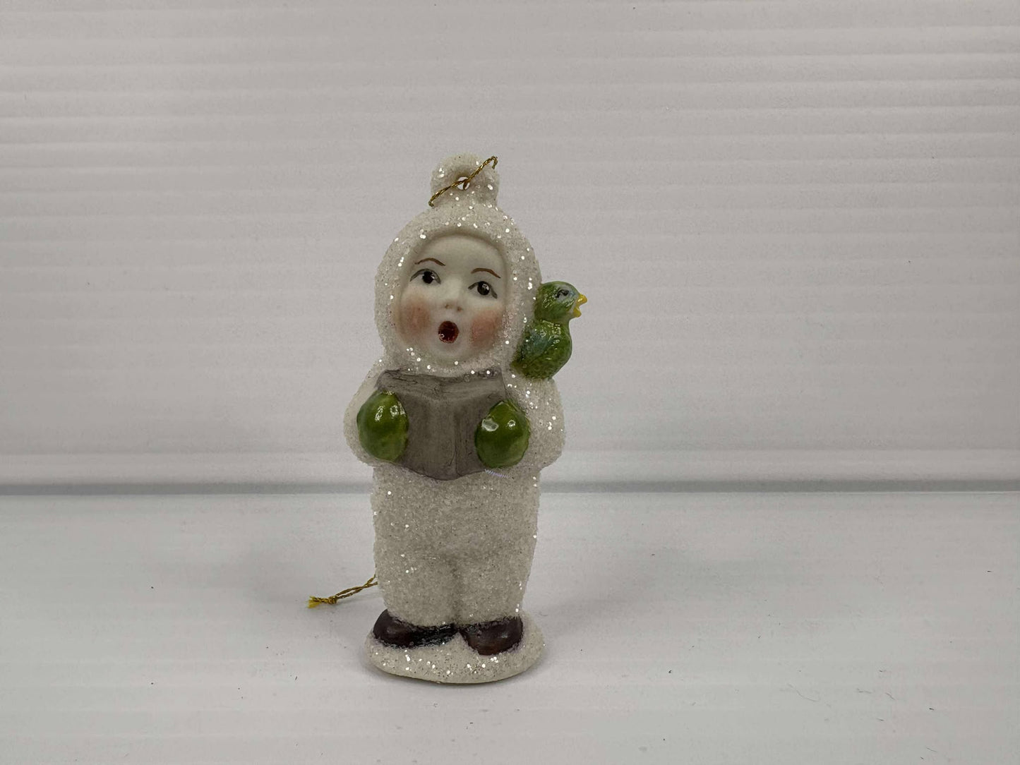 Handmade Porcelain Ornament – Caroling Child with Bird